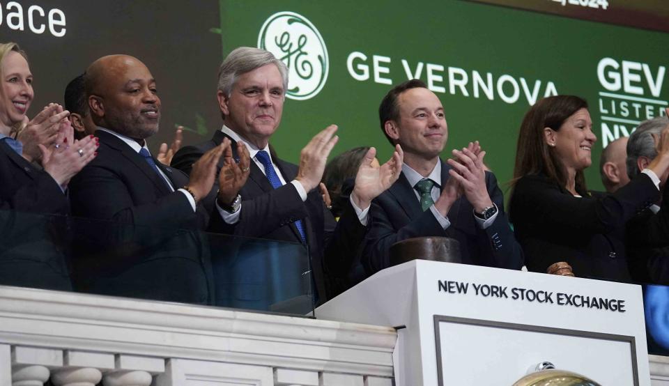 <p>TIMOTHY A. CLARY / AFP via Getty Images</p> GE Aerospace and GE Vernova chief executives and employees ring the opening bell at the New York Stock Exchange on April 2, 2024, when GE Vernova was listed