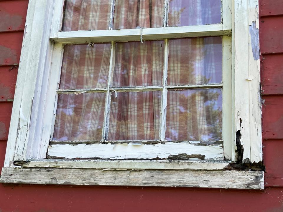 A deteriorating window frame of the historic Joseph Murray farmhouse in Middletown.