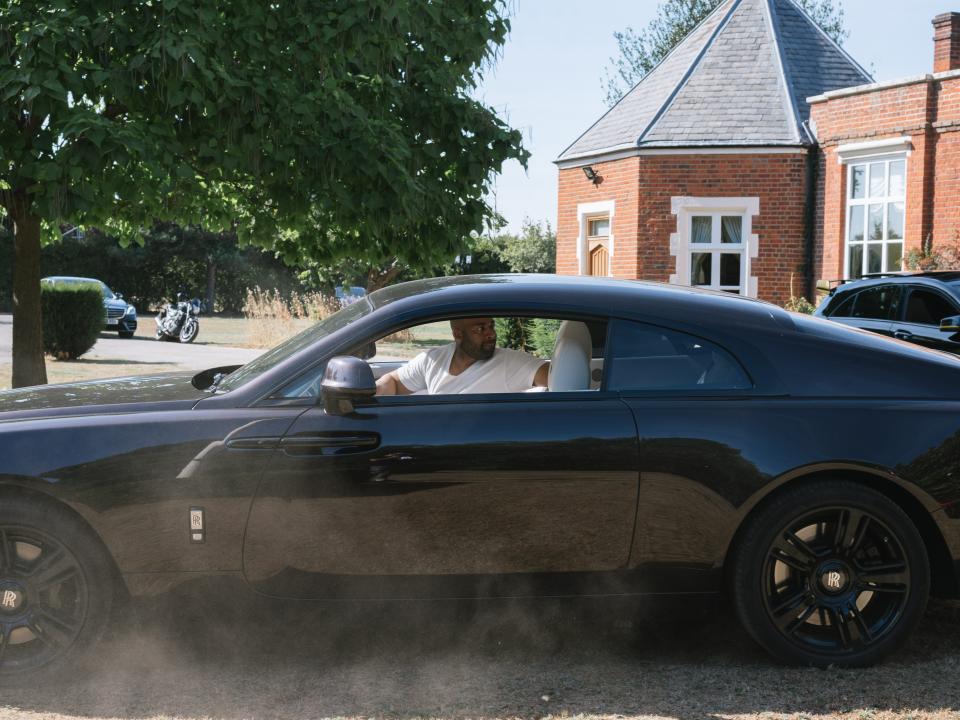 Ikenna Ordor reversing a black Rolls Royce onto a driveway.