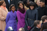 First lady Michelle Obama and daughters, Sasha Obama and Malia Obama arrive during the presidential inauguration on the West Front of the U.S. Capitol January 21, 2013 in Washington, DC. Barack Obama was re-elected for a second term as President of the United States. (Photo by Mark Wilson/Getty Images)