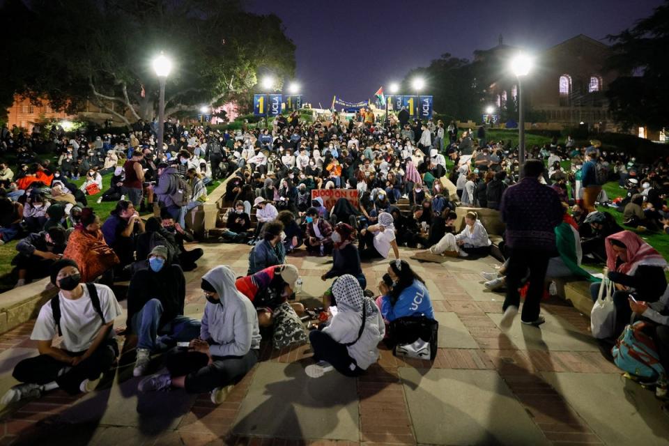 Supporters of the pro-Palestinian protesters sit on stairs at UCLA (AFP via Getty Images)