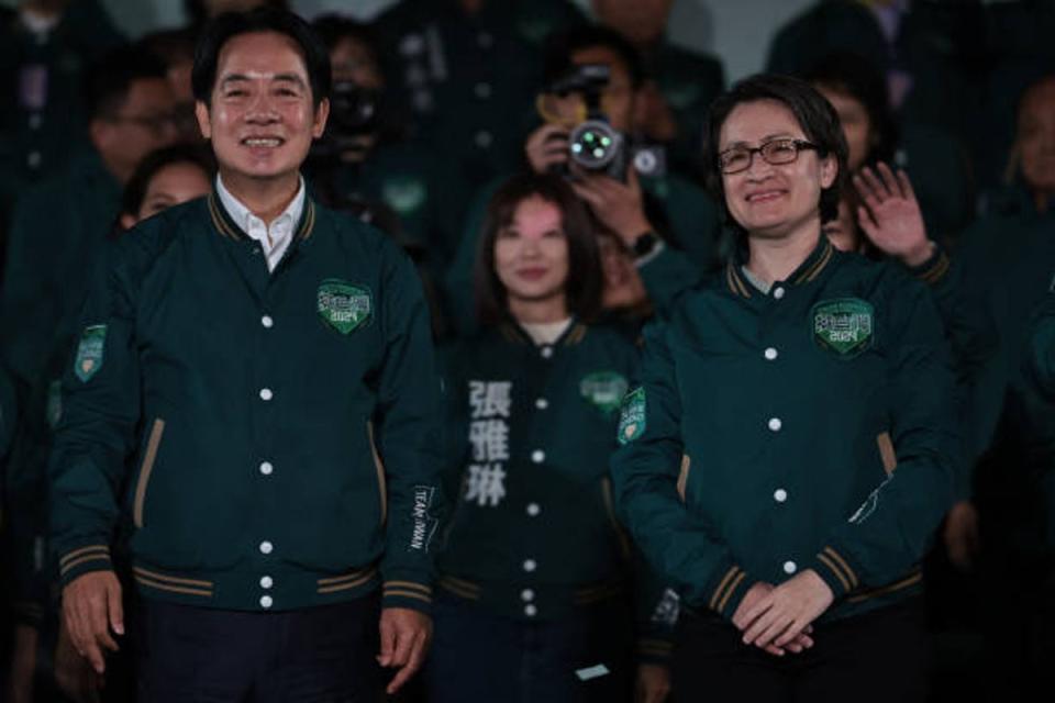 Taiwan’s President-elect Lai Ching-te (L) and his running mate Hsiao Bi-khim attend a rally outside the headquarters of the Democratic Progressive Party (DPP) in Taipei on 13 January 2024 (AFP via Getty Images)