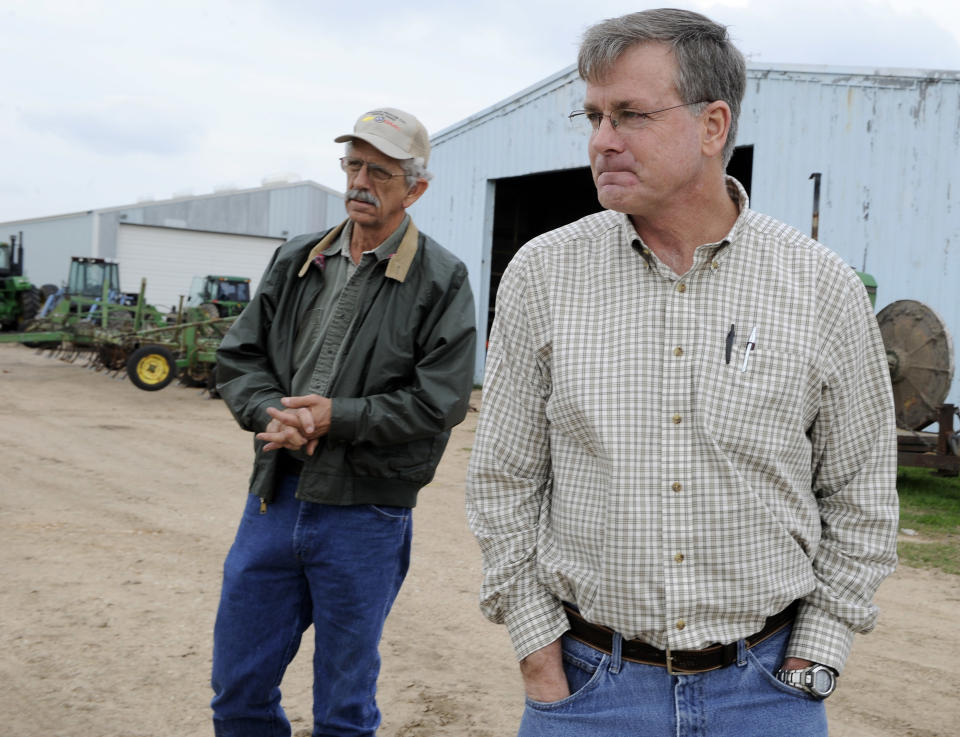 FILE - In this Feb. 8, 2012 file photo, Ron Gertson, right, and Billy Hefner talk about the affects of the drought and lack of water on the rice farming industry at Gertson's farm in Lissie, Texas. Gertson is supplementing his income by selling pipes to drill wells because he’s not getting water from Austin-area reservoirs for his crops. From Dallas to far-flung ranches and rice farms, Texans and officials are trying to capitalize on heightened drought awareness by adopting conservation plans that will ease the next crisis. (AP Photo/Pat Sullivan, File)