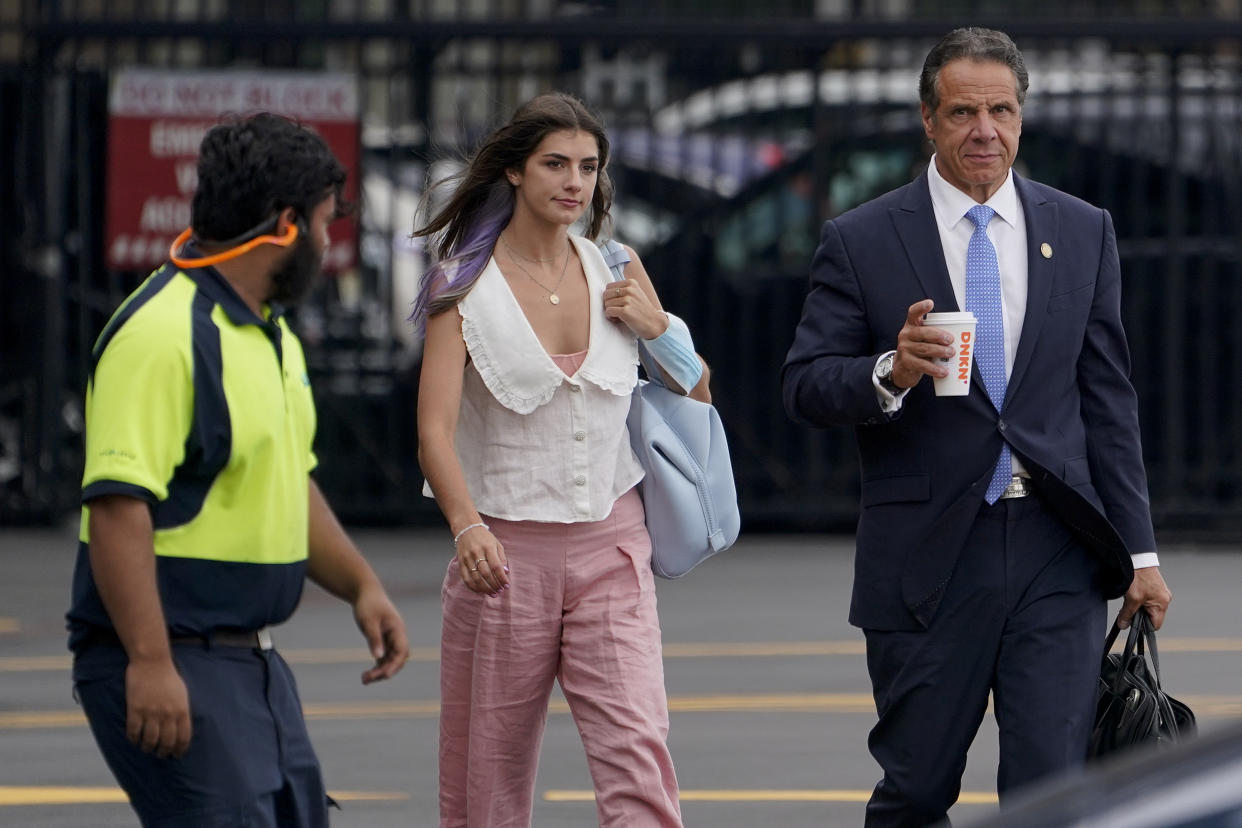 New York Gov. Andrew Cuomo, right, prepares to board a helicopter with his daughter Michaela Cuomo after announcing his resignation, Tuesday, Aug. 10, 2021, in New York. Cuomo says he will resign over a barrage of sexual harassment allegations. The three-term Democratic governor's decision, which will take effect in two weeks, was announced Tuesday as momentum built in the Legislature to remove him by impeachment. (AP Photo/Seth Wenig)