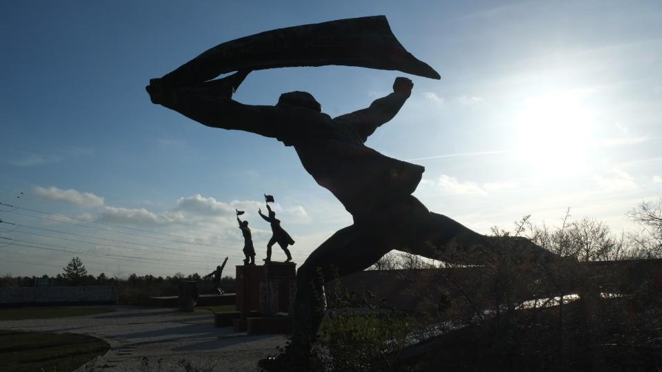 This 2013 photo shows the Republic of Councils Monument, a statue of a worker charging forward, now located in Memento Park, a field about 30 minutes away from central Budapest in Hungary. Many communist-era monuments were brought here after the fall of communism in Eastern Europe in 1989. This statue is the butt of irreverent jokes: Perhaps it’s a running beachgoer, some say, or a cloakroom attendant. (AP Photo/Sisi Tang)