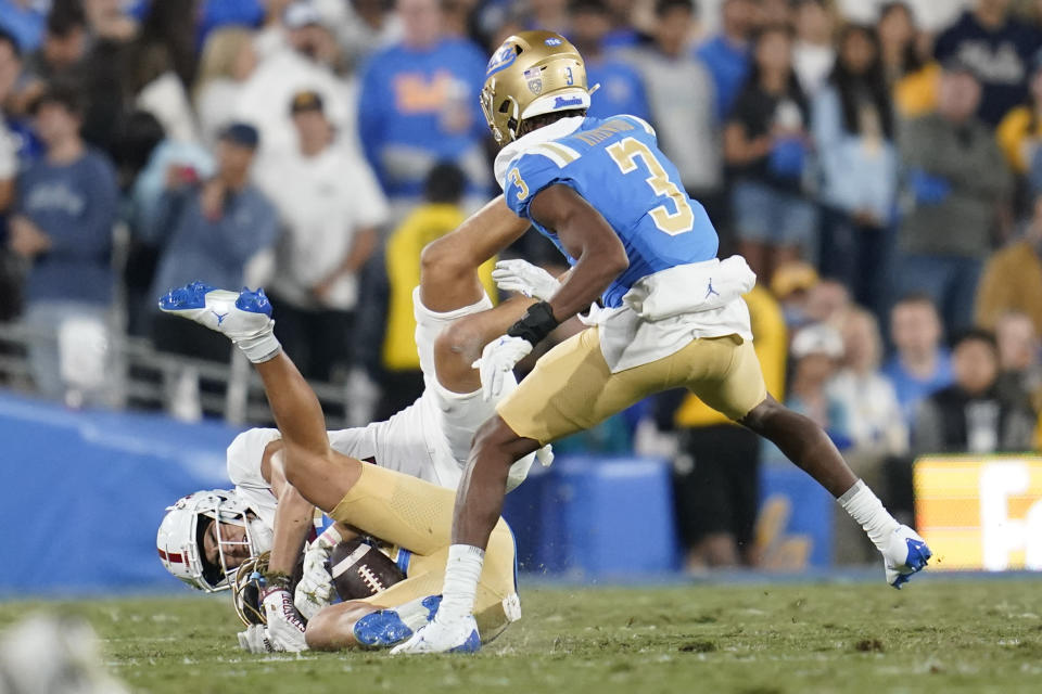 UCLA wide receiver Logan Loya (17) is tackled by Stanford wide receiver Brycen Tremayne (81) on a punt return during the first half of an NCAA college football game in Pasadena, Calif., Saturday, Oct. 29, 2022. Loya fumbled the ball and it was recovered by Stanford tight end Sam Roush (86). (AP Photo/Ashley Landis)