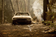 Following the Dixie Fire, a scorched vehicle rests in a driveway in the Indian Falls community of Plumas County, Calif., on Monday, July 26, 2021. (AP Photo/Noah Berger)