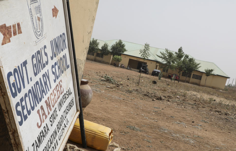 A sign pointos to the Government Girls Junior Secondary School from where more than 300 girls were abducted on Friday by gunmen, in Jangebe town, Zamfara state, northern Nigeria Saturday, Feb. 27, 2021. Nigerian police and the military have begun joint operations to rescue the more than 300 girls who were kidnapped from the boarding school, according to a police spokesman. (AP Photo/Ibrahim Mansur)