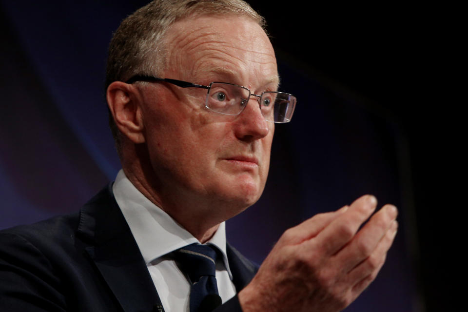 RBA governor Philip Lowe gestures while discussing interest rates.