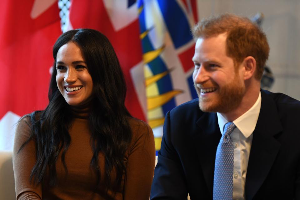 Britain's Prince Harry, Duke of Sussex and Meghan, Duchess of Sussex gesture during their visit to Canada House in thanks for the warm Canadian hospitality and support they received during their recent stay in Canada,  in London on January 7, 2020. (Photo by DANIEL LEAL-OLIVAS / various sources / AFP) (Photo by DANIEL LEAL-OLIVAS/AFP via Getty Images)