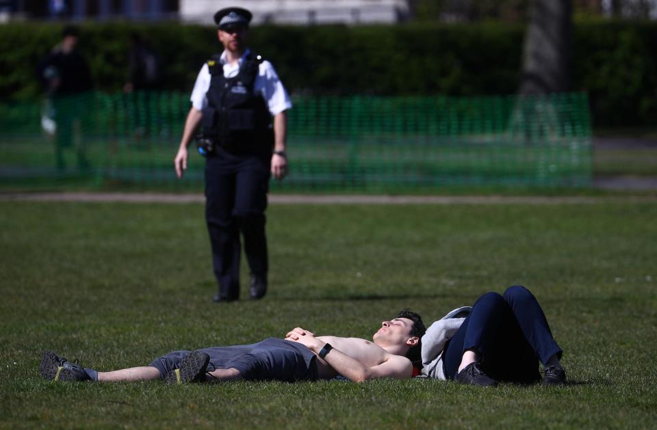 A man lies down in Greenwich Park (REUTERS)