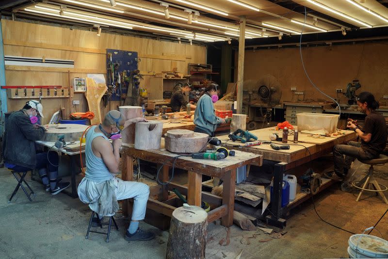 Workers process timber at the HK TimberBank factory in Hong Kong