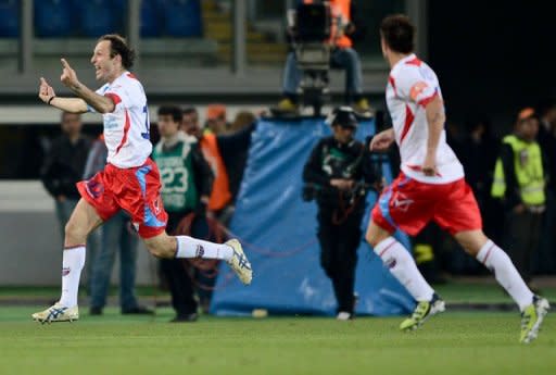 Catania defender Giovanni Marchese (L) celebrates after scoring against AS Roma during an Italian Serie A football match at Rome's Olympic stadium. Roma all but crashed out of European contention with a limp performance in a 2-2 draw at home to Catania