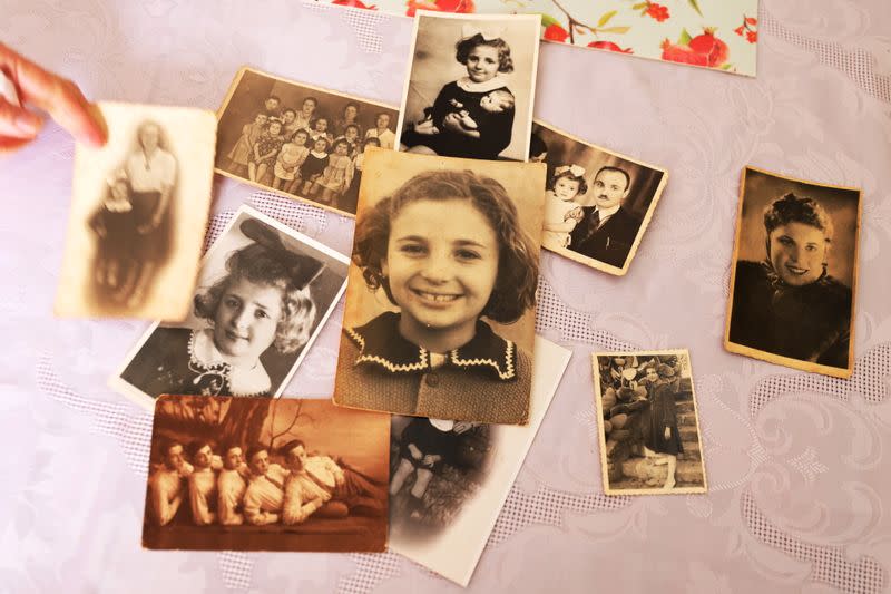 A collection of Holocaust survivor Leah Nebenzahl's family photographs are seen on a table during her interview with Reuters in Jerusalem