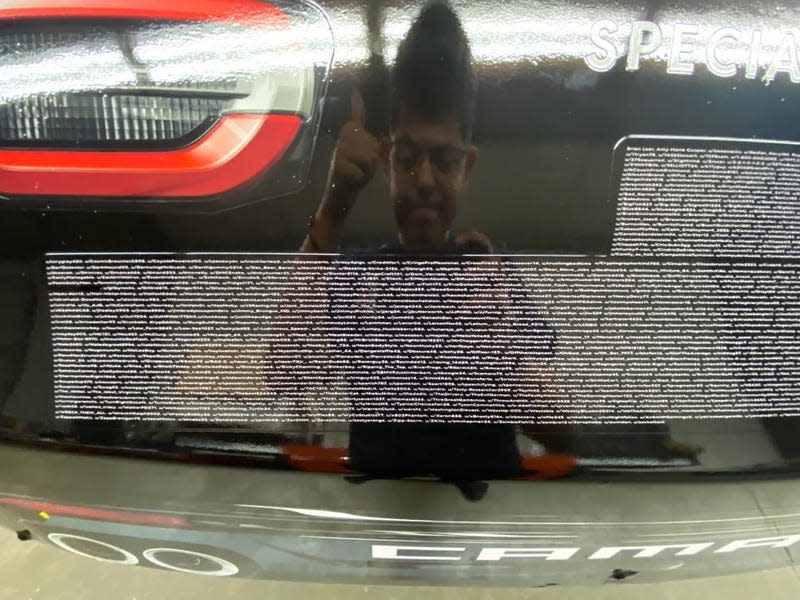 A photo of the names of 1,400 Reddit community members on a NASCAR race car.