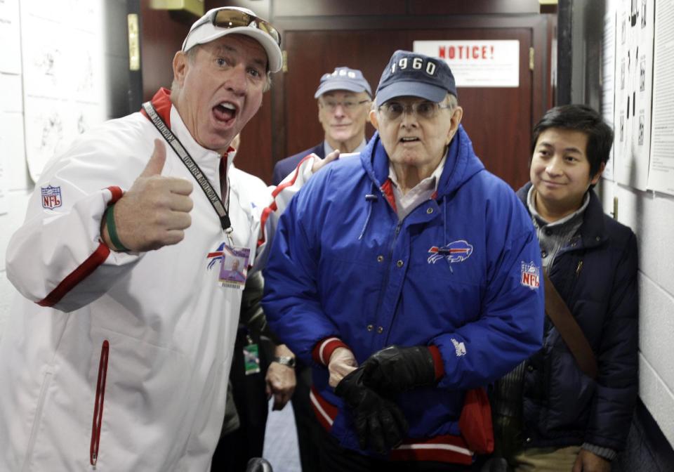 FILE - In this Nov. 6, 2011, file photo, former Buffalo Bills quarterback Jim Kelly, left, poses for a photo with Bills owner Ralph Wilson Jr., right, before an NFL football game against the New York Jets in Orchard Park, N.Y. Bills owner Wilson Jr. has died at the age of 95 at his home in Grosse Pointe Shores, Mich. Bills president Russ Brandon made the announcement at the NFL winter meetings in Orlando, Fla., Tuesday, March 25, 2014. Wilson Jr. was one of the original founders of the American Football League and owned the Bills for the last 54 years. (AP Photo/David Duprey, File)