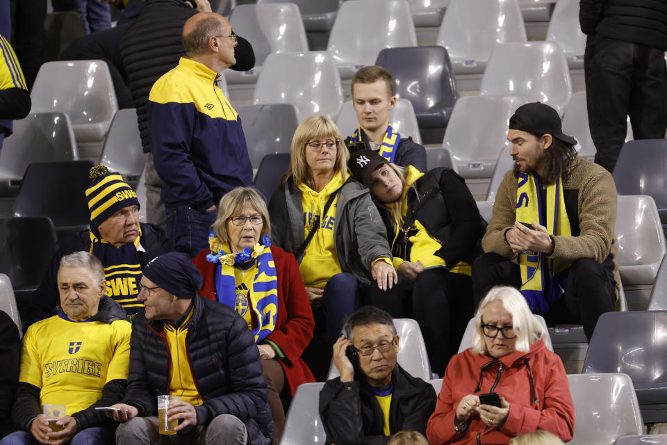 Sweden supporters react on stands during the Euro 2024 group F qualifying soccer match between Belgium and Sweden at the King Baudouin Stadium in Brussels, Monday, Oct. 16, 2023. Two Swedes were killed in a shooting late Monday in central Brussels, police said, prompting Belgium's prime minister and senior Cabinet minister to hunker down at their crisis center for an emergency meeting. (AP Photo/Geert Vanden Wijngaert)