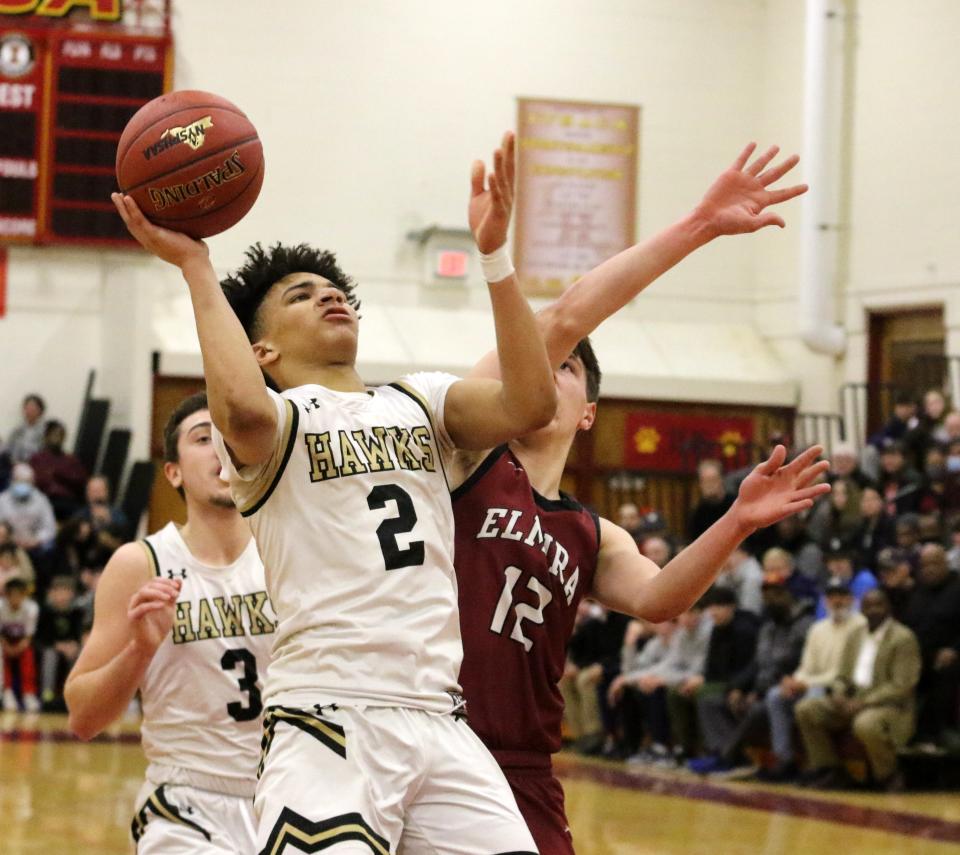 Corning's Isaiah Henderson goes up for a shot as Elmira's Mikey Middaugh defends during the Hawks' 76-56 win in the Section 4 Class AA boys basketball championship game March 4, 2022 at Ithaca High School.