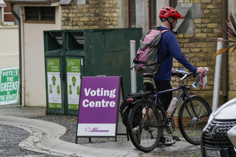 A man arrives at a polling station in Sydney, Australia, Monday, May 9, 2022. Early voting has begun in Australia's federal election with the opposition party hoping the first ballots will reflect its lead over the government in an opinion poll. (AP Photo/Mark Baker)