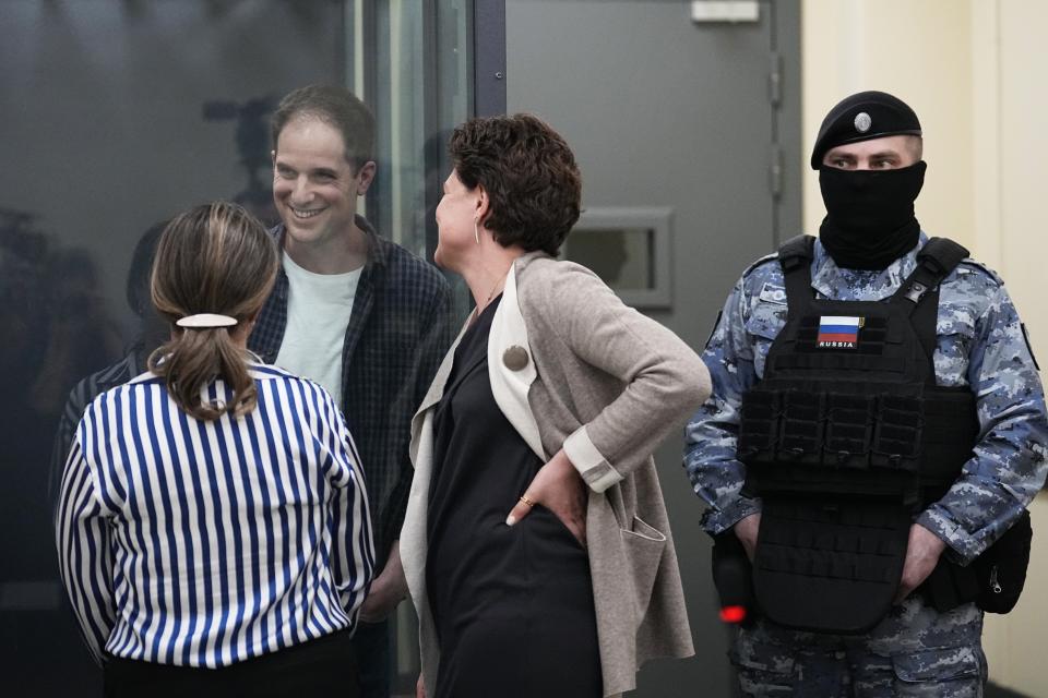 FILE - Wall Street Journal reporter Evan Gershkovich speaks with his lawyers in a court in Moscow, Russia, on April 23, 2024. Fifteen months after he was arrested in the city of Yekaterinburg on espionage charges, Gershkovich returns there for his trial starting Wednesday, June 26, 2024, behind closed doors. Gershkovich, his employer and the U.S. government deny the charges. (AP Photo/Alexander Melnichenko, File)