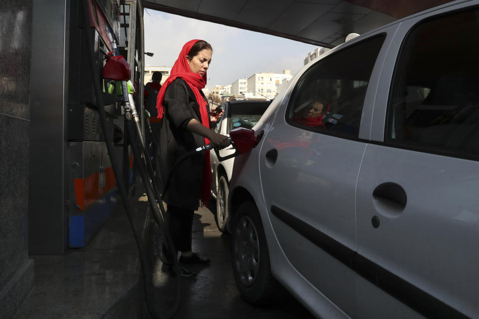 A woman fills her car at a gas station in Tehran, Iran, Friday, Nov. 15, 2019. Authorities have imposed rationing and increased the prices of fuel. The decision came following months of speculations about possible rationing after the U.S. in 2018 reimposed sanctions that sent Iran's economy into free-fall following Washington withdrawal from 2015 nuclear deal between Iran and world powers. (AP Photo/Vahid Salemi)