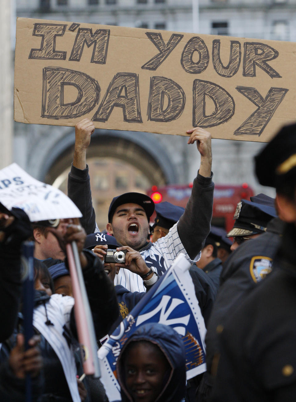 FILE - In this Nov. 6, 2009, file photo, a fan holds a sign referring to Philadelphia Phillies pitcher Pedro Martinez, who was the losing pitcher in Game 6 of the World Series, during a ticker-tape parade along Broadway celebrating the New York Yankees 27th World Series championship, in New York. The Phillies lost to the New York Yankees in six games and Martinez went 0-2 in two starts against the Yankees with a 6.30 ERA _ but has long said he was sick in his Game 6 start at Yankee Stadium and always wished he could have that one back. (AP Photo/Kathy Willens, File)