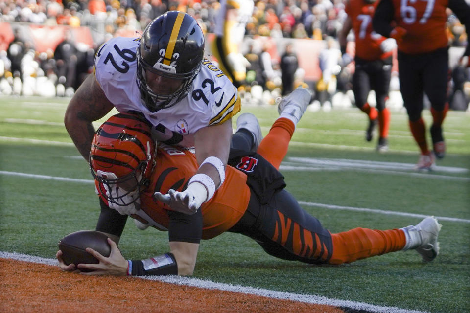 Cincinnati Bengals quarterback Joe Burrow, bottom, is hit by defensive end Isaiahh Loudermilk (92) as he scrambles his way to a touchdown in the first half of an NFL football game, Sunday, Nov. 28, 2021, in Cincinnati. (AP Photo/Jeff Dean)