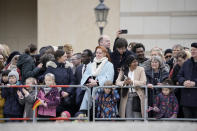 People wait to watch the arrival of Britain's King Charles III and Camilla, the Queen Consort, in front of the Brandenburg Gate in Berlin, Tuesday, March 29, 2022. King Charles III arrived Wednesday for a three-day official visit to Germany. (AP Photo/Matthias Schrader)