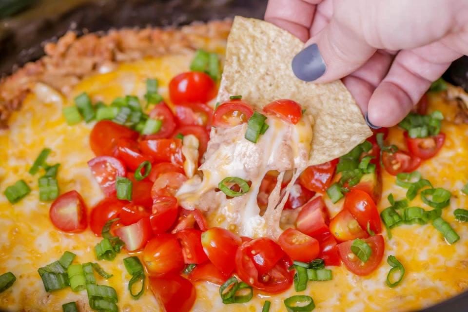 <p>Lil' Luna</p><p>Buy a couple of extra bags of tortilla chips. You're going to need them with this one!</p><p><strong>Get the recipe: <a href="https://lilluna.com/crock-pot-bean-dip/" rel="nofollow noopener" target="_blank" data-ylk="slk:Crock Pot Bean Dip;elm:context_link;itc:0;sec:content-canvas" class="link ">Crock Pot Bean Dip</a></strong></p>
