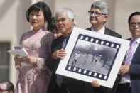 Pulitzer Prize-winning photographer Nick Ut, center, flanked by Kim Phuc, holds the" Napalm Girl", his Pulitzer Prize winning photo as they wait to meet with Pope Francis during the weekly general audience in St. Peter's Square at The Vatican, Wednesday, May 11, 2022. Ut and UNESCO Ambassador Kim Phuc are in Italy to promote the photo exhibition "From Hell to Hollywood" resuming Ut's 51 years of work at the Associated Press, including the 1973 Pulitzer-winning photo of Kim Phuc fleeing her village after it was accidentally hit by napalm bombs dropped by South Vietnamese forces. (AP Photo/Gregorio Borgia)