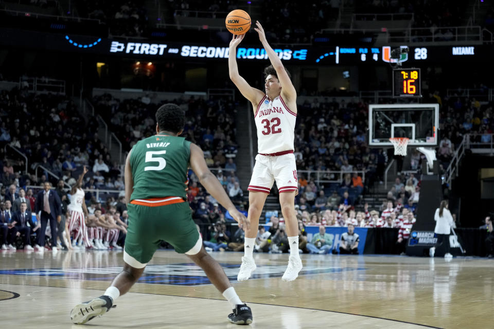 Indiana's Trey Galloway (32) shoots over Miami's Harlond Beverly (5) in the first half of a second-round college basketball game in the NCAA Tournament, Sunday, March 19, 2023, in Albany, N.Y. (AP Photo/John Minchillo)