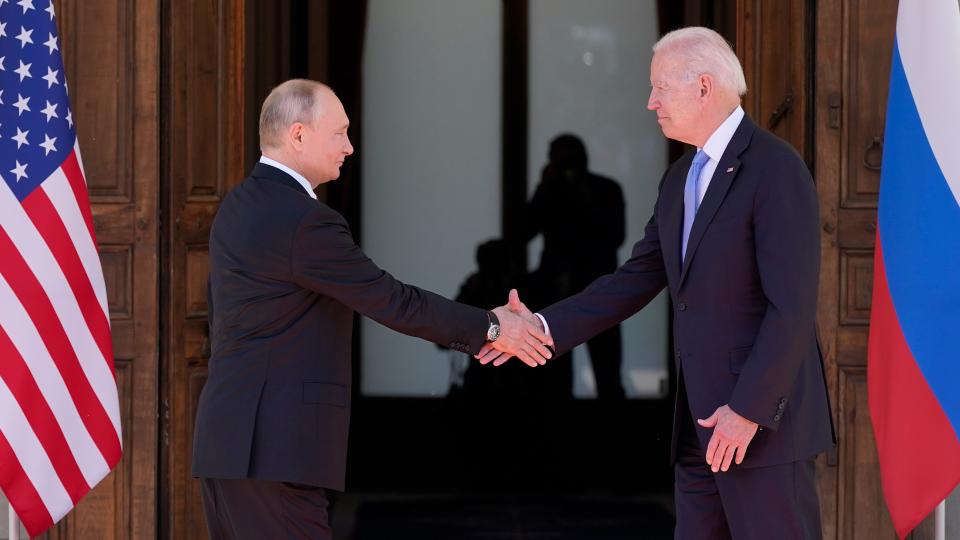 President Joe Biden and Russian President Vladimir Putin greet one another ahead of a summit in Geneva on June 16, 2021.