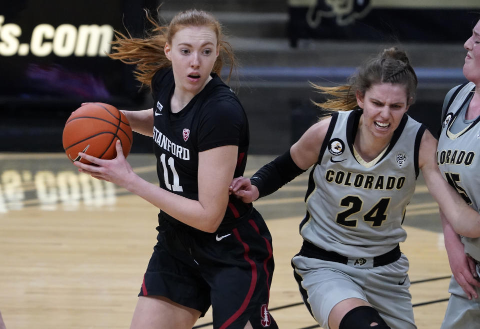 Stanford forward Ashten Prechtel, left, looks to pass the ball as Colorado guard Aubrey Knight runs into teammate and forward Charlotte Whittaker in the first half of an NCAA college basketball game Sunday, Jan. 17, 2021, in Boulder, Colo. (AP Photo/David Zalubowski)