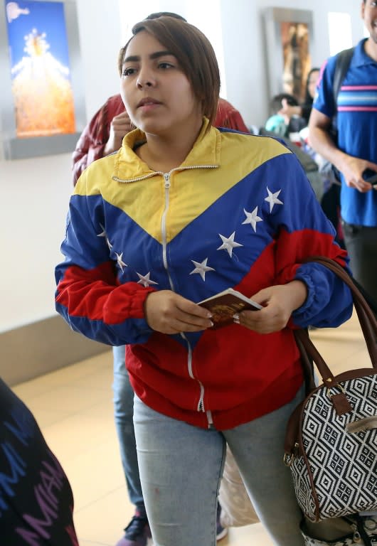 A Venezuelan migrant waits to board her flight at Lima's international airport, one of a group of about 100 who took up an a government offer to fly home after experiencing difficulties in Peru, on August 27, 2018