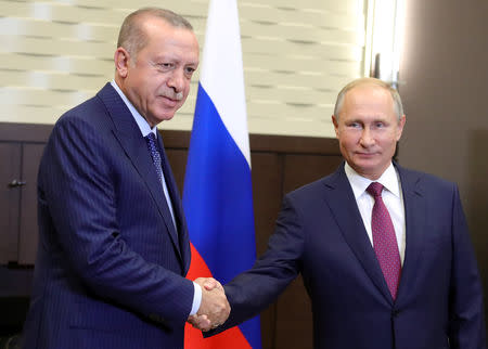 Russian President Vladimir Putin (R) shakes hands with his Turkish counterpart Tayyip Erdogan during a meeting in Sochi, Russia September 17, 2018. Sputnik/Mikhail Klimentyev/Kremlin via REUTERS