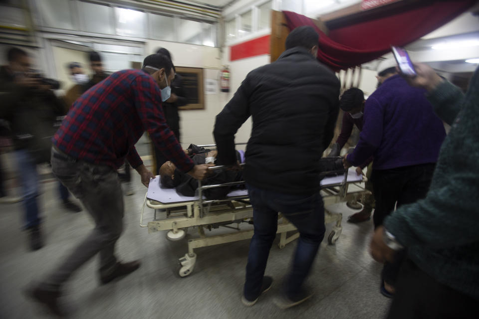 A Kashmiri man injured in an attack is brought for treatment at a hospital in Srinagar, Indian controlled Kashmir, Monday, March. 29, 2021. Gunmen killed an elected official of India’s ruling party and a policeman in disputed Kashmir on Monday, police said. (AP Photo/Mukhtar Khan)