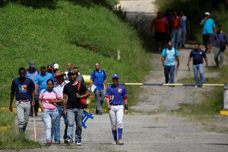 People attend to a baseball showcase in Caracas, Venezuela August 22, 2017. REUTERS/Carlos Garcia Rawlins/Files