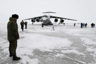 A Russian officer stands near a landed Il-76 military cargo plane on the Alexandra Land island near Nagurskoye, Russia, Monday, May 17, 2021. Once a desolate home mostly to polar bears, Russia's northernmost military outpost is bristling with missiles and radar and its extended runway can handle all types of aircraft, including nuclear-capable strategic bombers, projecting Moscow's power and influence across the Arctic amid intensifying international competition for the region's vast resources. (AP Photo/Alexander Zemlianichenko)