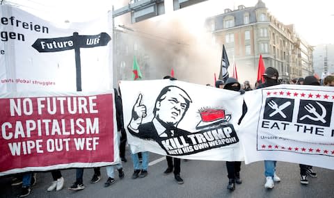 Protesters march during an anti-WEF and anti-Trump demonstration in Bern - Credit: Arnd Wiegmann/REUTERS