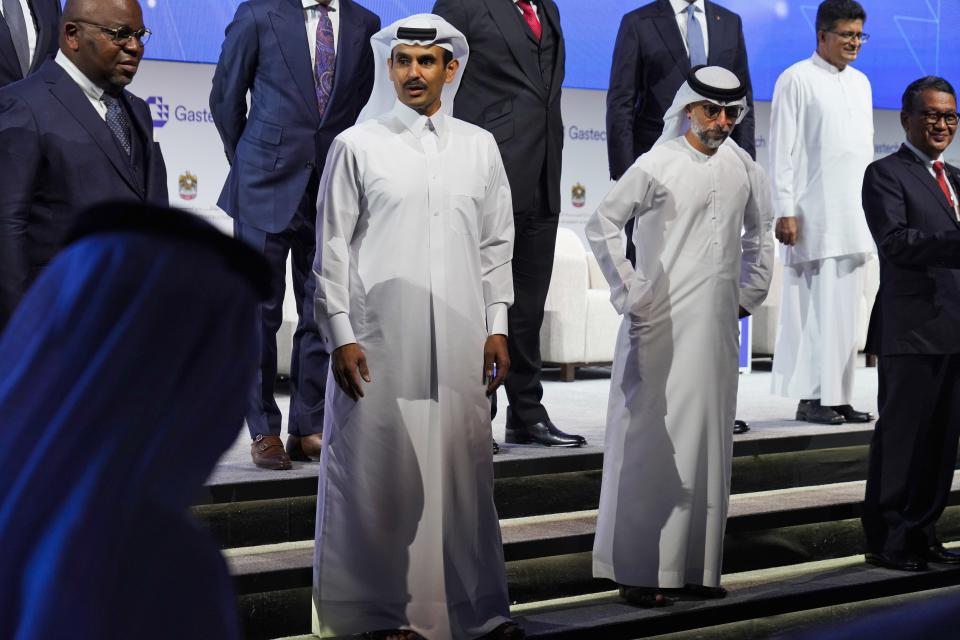 Qatar's Minister of State for Energy Affairs Saad Sherida al-Kaabi, center left, awaits a posed portrait with Emirati Energy and Infrastructure Minister Suhail al-Mazrouei, center right, during Gastech 2021 conference in Dubai, United Arab Emirates, Tuesday, Sept. 21, 2021. Energy officials from Qatar and Turkey, long-standing foes of the United Arab Emirates, descended on Dubai along with hundreds of other executives on Tuesday, flocking to the largest gas expo in the world and the industry's first in-person conference since the pandemic began. (AP Photo/Jon Gambrell)