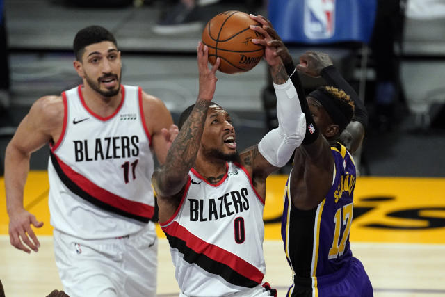 Los Angeles Lakers forward LeBron James (23) points at a team mate during  the second half of an NBA basketball game against the Portland Trail  Blazers Friday, Feb. 26, 2021, in Los