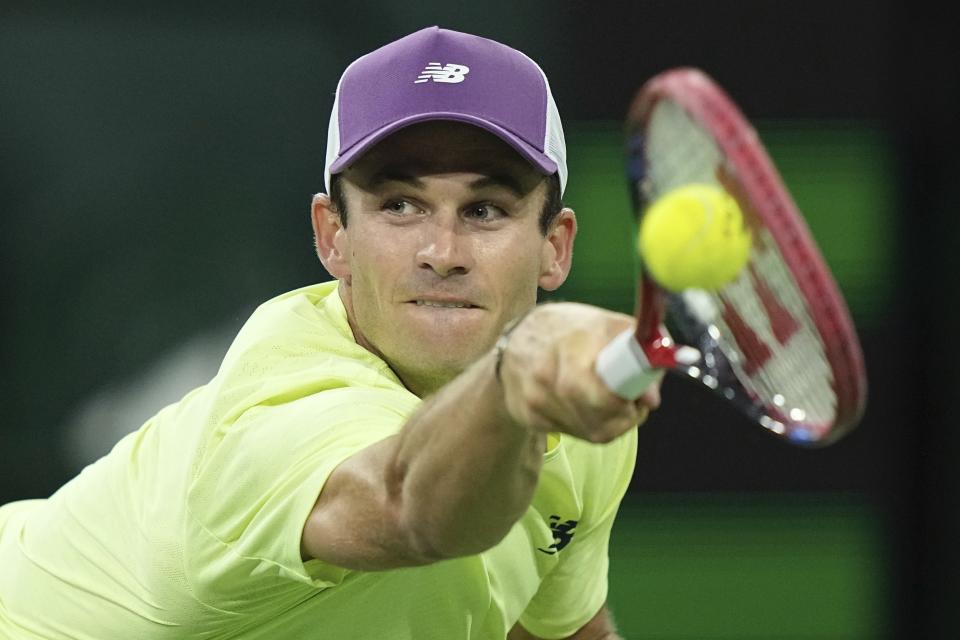 Tommy Paul, the United States, returns a shot to Daniil Medvedev, of Russia, at the BNP Paribas Open tennis tournament Saturday, March 16, 2024, in Indian Wells, Calif. (AP Photo/Mark J. Terrill)