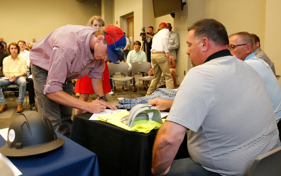 Jordan Williams signs his apprenticeship letter with Local Union 372's Apprenticeship Training Program. Students from across Tuscaloosa City and County Schools participate in the West Alabama Regional Signing Day at Tuscaloosa Career and Technology Academy Thursday, May 2, 2019. Students onto apprenticeship programs and career technical education and ready-to-work programs with area industries. [Staff Photo/Gary Cosby Jr.]