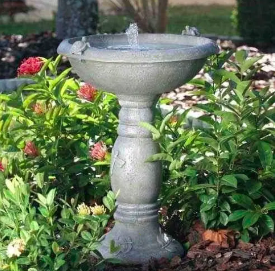 A small bird fountain in a garden