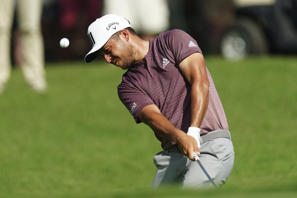 Xander Schauffele chips to the green on the fifth hole during the third round of the Tour Championship golf tournament at East Lake Golf Club Saturday, Aug. 27, 2022, in Atlanta. (AP Photo/John Bazemore)