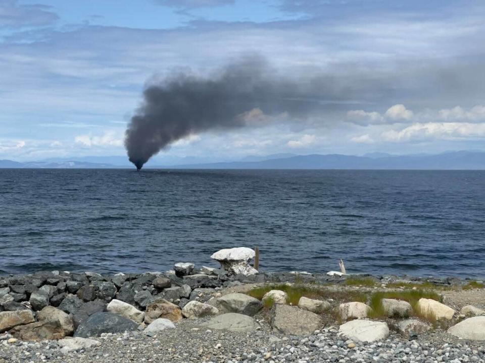 Two people had to be rescued from a 40-foot pleasure craft that caught fire off Qualicum Beach on Monday.  (submitted by Court Brooker - image credit)