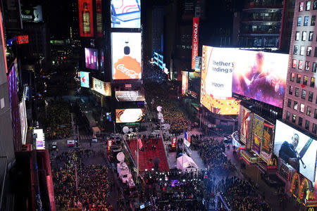 Revelers brave freezing cold temperatures in Times Square ahead of New Year's celebrations in Manhattan, New York, U.S., December 31, 2017. REUTERS/Darren Ornitz