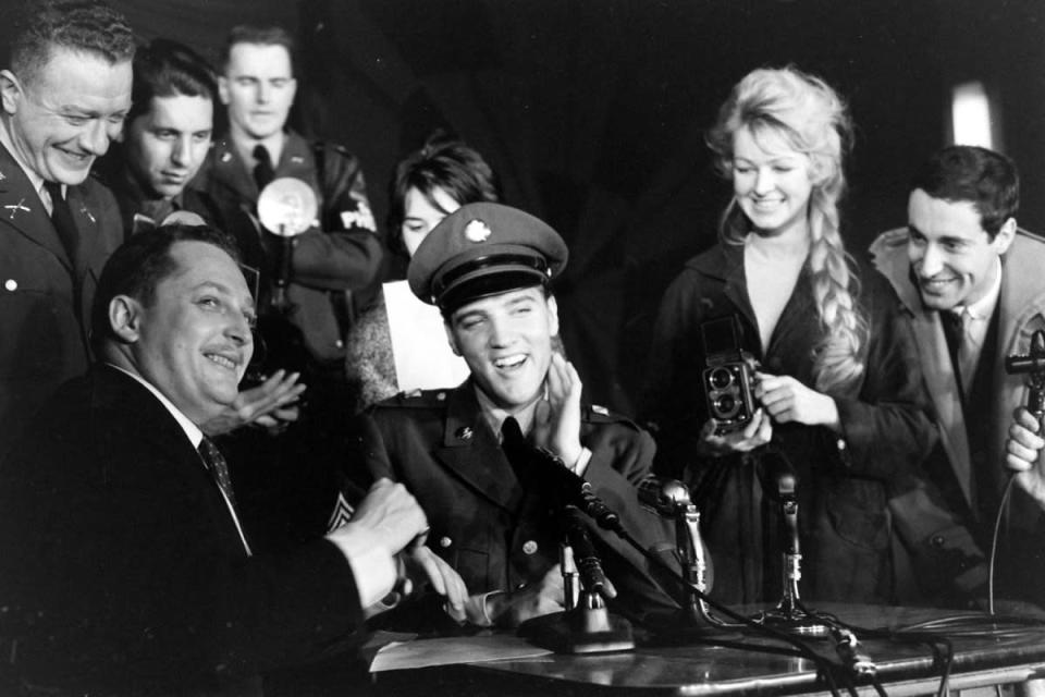 Not originally published in LIFE. Sgt. Elvis Presley at a press conference before leaving Germany, March 1960. (James Whitmore—Time & Life Pictures/Getty Images) <br> <br> <a href="http://life.time.com/culture/elvis-presley-life-photos-of-the-king-leaving-the-army-march-1960/#1" rel="nofollow noopener" target="_blank" data-ylk="slk:Click here to see the full collection at LIFE.com;elm:context_link;itc:0;sec:content-canvas" class="link ">Click here to see the full collection at LIFE.com</a>