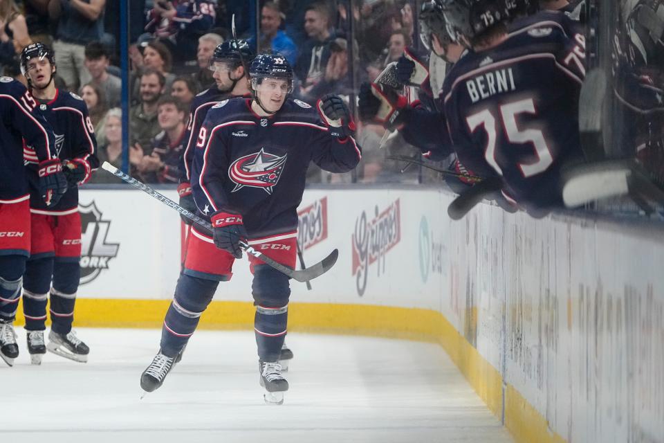 Columbus Blue Jackets center Tyler Angle (39) gets high fives from the bench after scoring his first NHL goal during the second period of the NHL hockey game against the Buffalo Sabres at Nationwide Arena in Columbus on April 14, 2023.