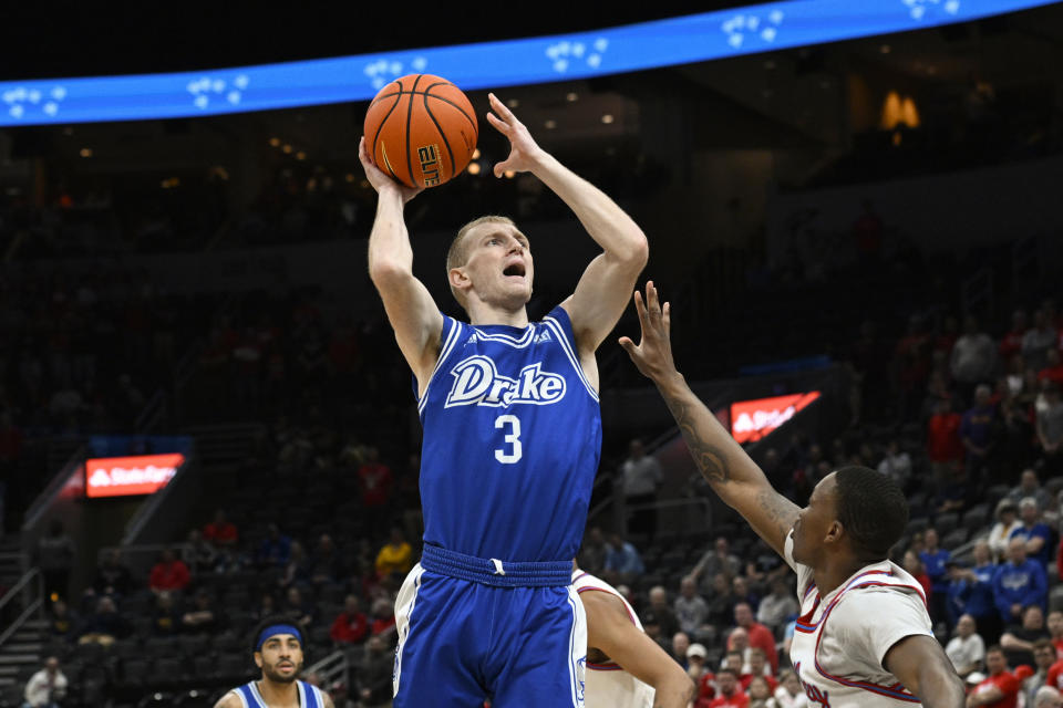 Drake guard Garrett Sturtz (3) shoots as Bradley guard Duke Deen, right, defends during the first half of the championship game in the MVC basketball tournament, Sunday, March 5, 2023, in St. Louis. (AP Photo/Joe Puetz)